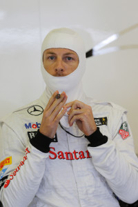 Jenson Button puts on his fire proof balaclava in the garage.