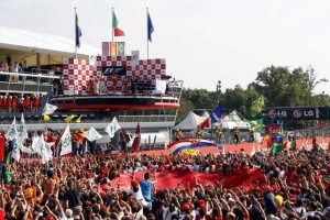Supporters of Ferrari Formula One driver Alonso of Spain celebrate under the podium after the Italian F1 Grand Prix at the Monza circuit