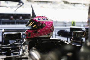 Jenson Button's helmet waits on the top of his car in the garage.