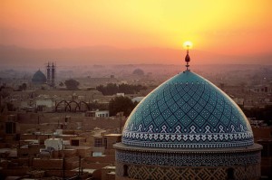 Sunset inflames the crescent symbol atop the dome of the Jame Masjid.