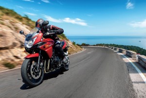 Turning mountain highway with blue sky and sea on a background